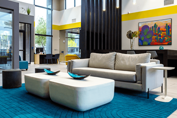 Las Vegas apartment for rent - A modern living room with a white couch and a blue rug.