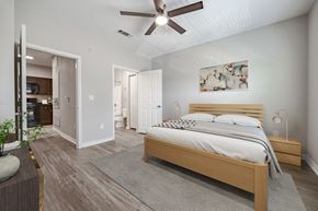 San Antonio apartment for rent - A bedroom with a large bed and a ceiling fan.