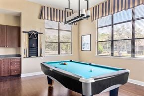 Jacksonville apartment for rent - A pool table in a room with a striped awning over the window.