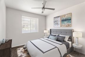 Phoenix apartment for rent - A bedroom with a large bed and a ceiling fan.
