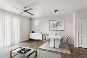 Phoenix apartment for rent - A modern dining room with a glass coffee table and white chairs.