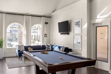 Stockton apartment for rent - A pool table is in the middle of a living room.