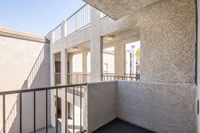 Santa Clarita apartment for rent - A white building with a balcony and a staircase.