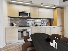 Los Angeles apartment for rent - A modern kitchen with a black table and brown chairs.