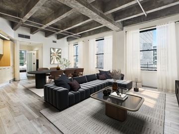 Los Angeles apartment for rent - A modern living room with a black sofa and a wooden coffee table.