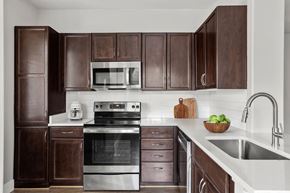Surprise apartment for rent - A kitchen with brown cabinets and stainless steel appliances.