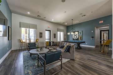 Surprise apartment for rent - A living room with a pool table and a couch.