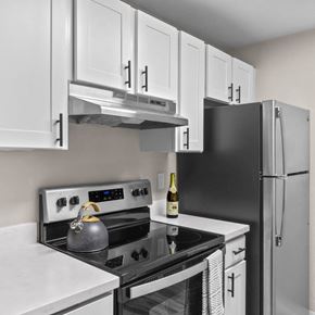 Renton apartment for rent - A black fridge sits next to a white counter in a kitchen.