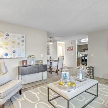 Renton apartment for rent - A living room with a grey sofa and a grey coffee table with a glass jar on it.