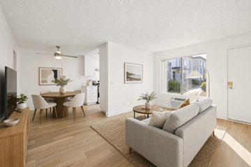 El Cajon apartment for rent - A living room with a grey couch and a wooden floor.