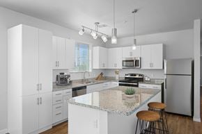 Phoenix apartment for rent - A kitchen with white cabinets and a granite countertop.