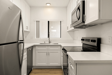 El Cajon apartment for rent - A kitchen with white cabinets and appliances.