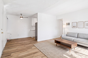 El Cajon apartment for rent - A living room with a grey couch and a wooden coffee table.