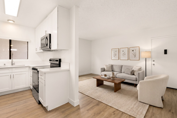 El Cajon apartment for rent - A modern living room with a grey couch and a wooden coffee table.