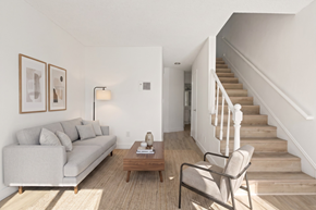 San Diego apartment for rent - A living room with a couch, chair, and stairs.