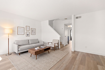 El Cajon apartment for rent - A living room with a grey couch and a wooden coffee table.