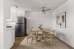 Ramona apartment for rent - A dining room with a table set for two and a refrigerator in the corner.