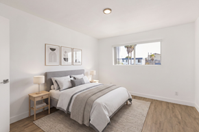 National City apartment for rent - A bedroom with a large bed and a window overlooking a street.