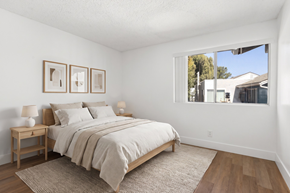 Ramona apartment for rent - A bedroom with a large bed and two nightstands.