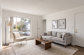National City apartment for rent - A living room with a grey couch, a chair, a coffee table, and pictures on the wall.