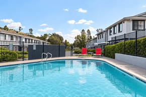 El Cajon apartment for rent - A swimming pool in front of a row of houses.