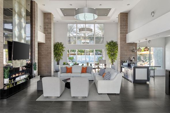 Phoenix apartment for rent - A modern living room with a white couch and a fireplace.