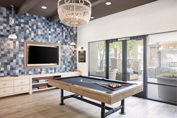 Designer clubhouse featuring multiple flat screens & a billiards table