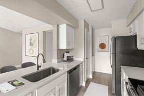 Mesa apartment for rent - A kitchen with a black refrigerator and white cabinets.