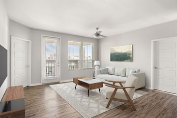 Gilbert apartment for rent - A living room with a white couch, a wooden coffee table, and a painting on the wall.