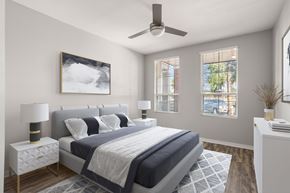 Gilbert apartment for rent - A bedroom with a large bed and a ceiling fan.