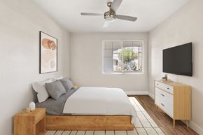 Peoria apartment for rent - A bedroom with a bed, nightstand, and a television.