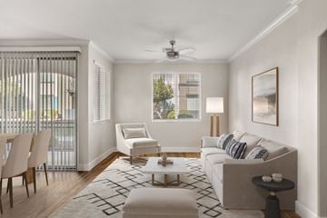 Peoria apartment for rent - A living room with a white couch, a chair, a coffee table, and a painting on the wall.