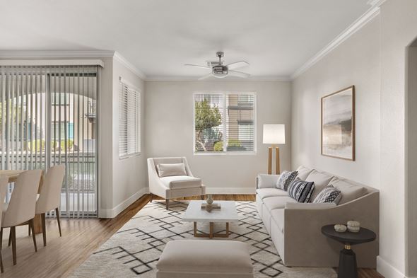 Peoria apartment for rent - A living room with a white couch, a chair, a coffee table, and a painting on the wall.