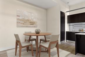 Los Angeles apartment for rent - A dining room with a wooden table and chairs.