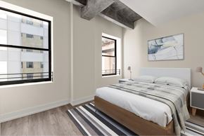 Los Angeles apartment for rent - A bedroom with a large bed and a window overlooking a building.