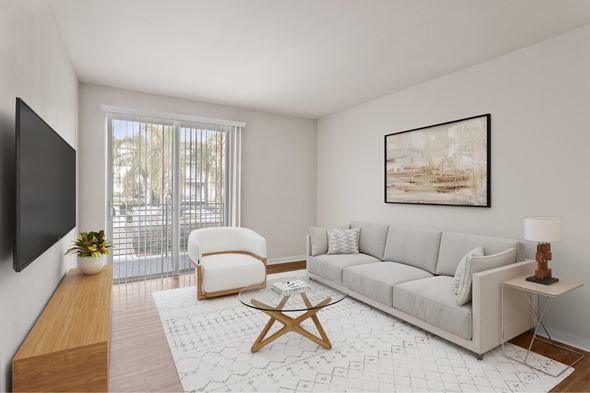 Los Angeles apartment for rent - A living room with a grey couch, a wooden table, and a painting on the wall.