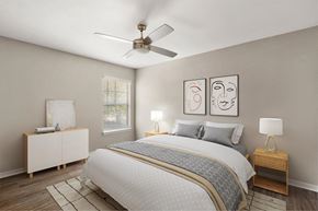 Jacksonville apartment for rent - A bedroom with a bed, nightstands, and a ceiling fan.