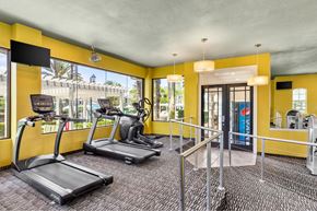 Jacksonville apartment for rent - A gym with treadmills and a television.
