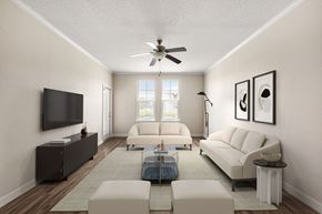 Sarasota apartment for rent - A living room with a white couch, a coffee table, and a flat screen TV.