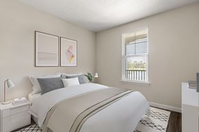 Sarasota apartment for rent - A bedroom with a large bed and a window with blinds.