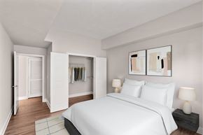 Charlotte apartment for rent - A bedroom with a large bed and a painting on the wall.