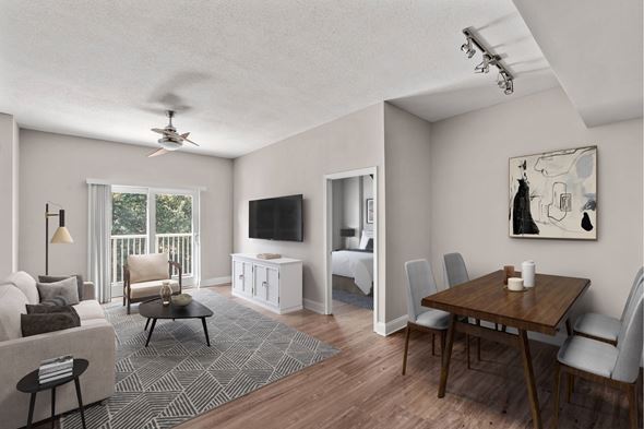 Charlotte apartment for rent - A living room with a television, a couch, a chair, a table, and a painting on the wall.