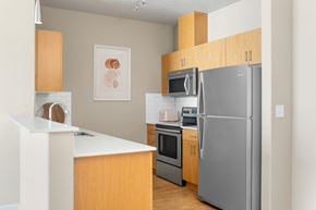 Hillsboro apartment for rent - A modern kitchen with wooden cabinets and stainless steel appliances.