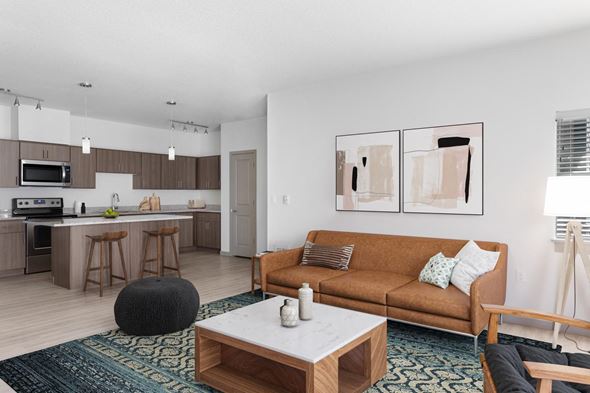 Oregon City apartment for rent - A modern living room with a brown couch and a coffee table.