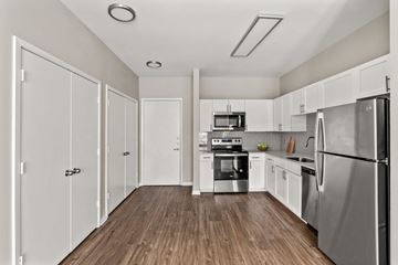 Frisco apartment for rent - A kitchen with white cabinets and stainless steel appliances.