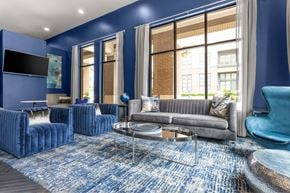 Frisco apartment for rent - A living room with blue walls and furniture.