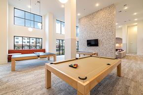 Haslet apartment for rent - A pool table in a room with a TV and a bench.