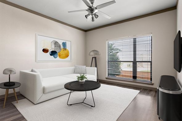 San Antonio apartment for rent - A living room with a white sofa, a small table, a television, and a painting on the wall.