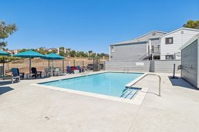 Spring Valley apartment for rent - A swimming pool with a slide and a fence.