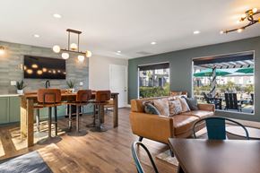 El Cajon apartment for rent - A modern dining room with a wooden table and chairs.
